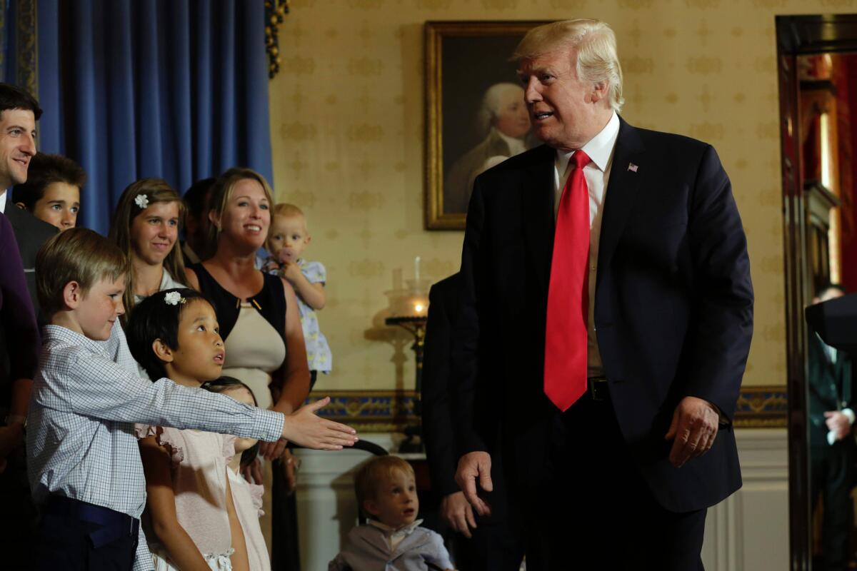 President Trump greets people he says were "victims of Obamacare" at White House event on Monday.