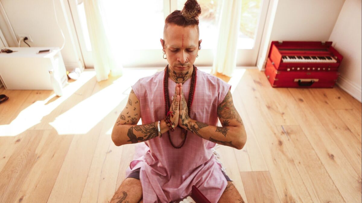 Puja Singh Titchkosky — who is a part-time stick-and-poke tattoo artist, part-time yoga teacher — plays the harmonium, a pump organ popular in Indian culture, and sings while students are lying in savasana.