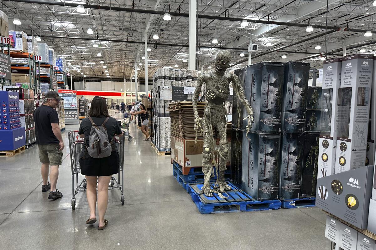 Shoppers pass a display of Halloween goods in a Costco warehouse.
