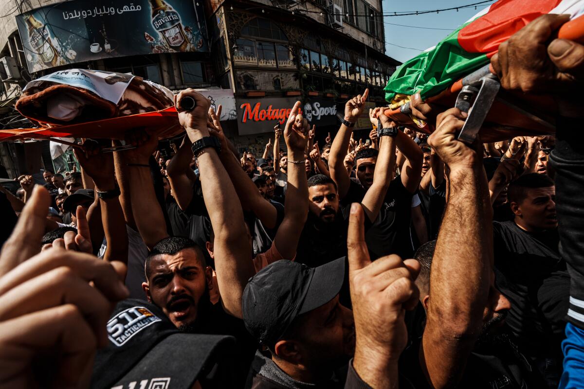 Mourners at a funeral procession for two men killed in an Israeli airstrike