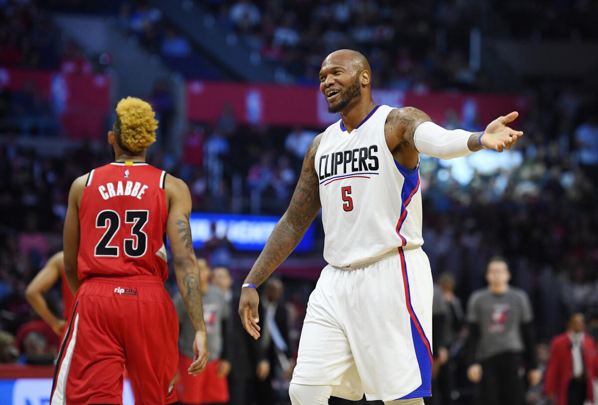 Clippers center Marreese Speights, right, tries to fire up the crowd as Trail Blazers guard Allen Crabbe walks away during the first half on Nov. 9.