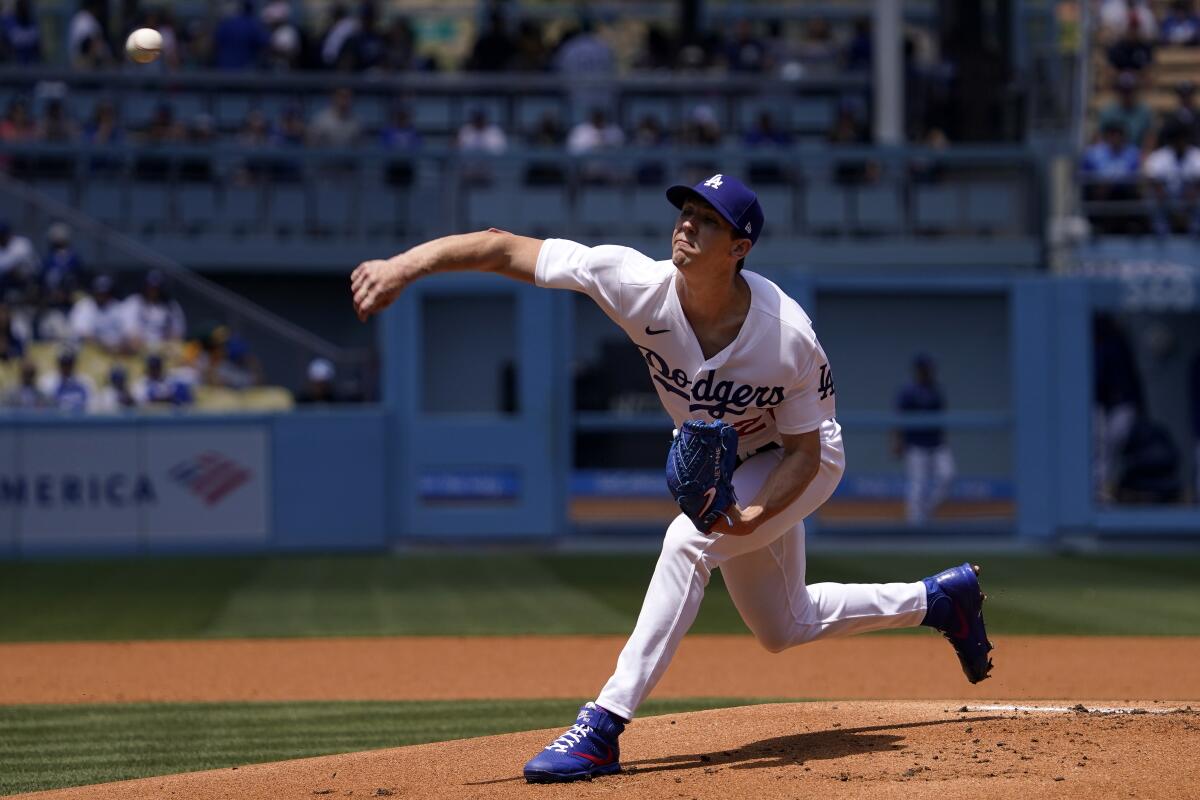 Dodgers starting pitcher Walker Buehler throws to home.