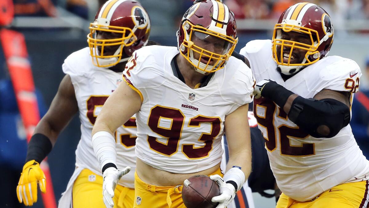 Redskins linebacker Trent Murphy (93) celebrates with teammates after sacking Bears quarterback Jay Cutler (not pictured) and recovering a subsequent fumble during the 2015 season.