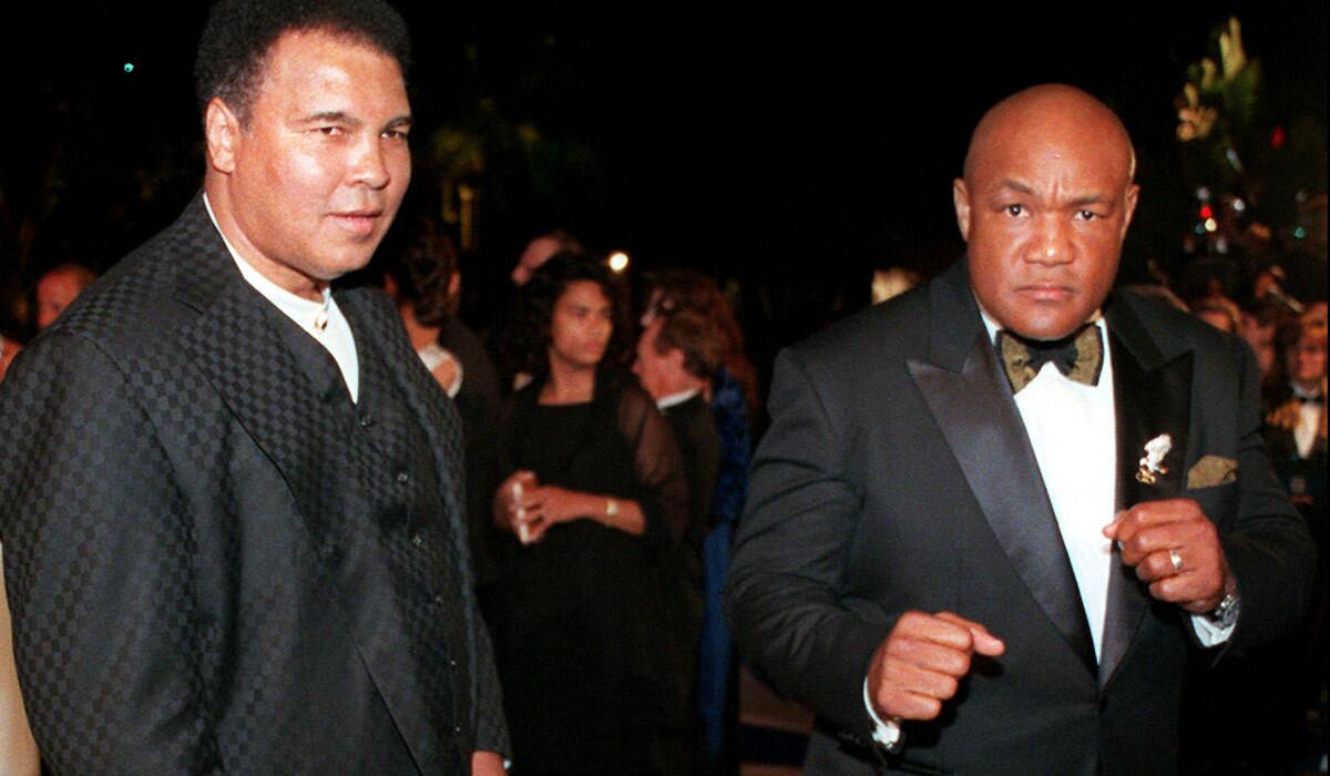 Muhammad Ali, left, and George Foreman arrive at a Vanity Fair Oscar party.