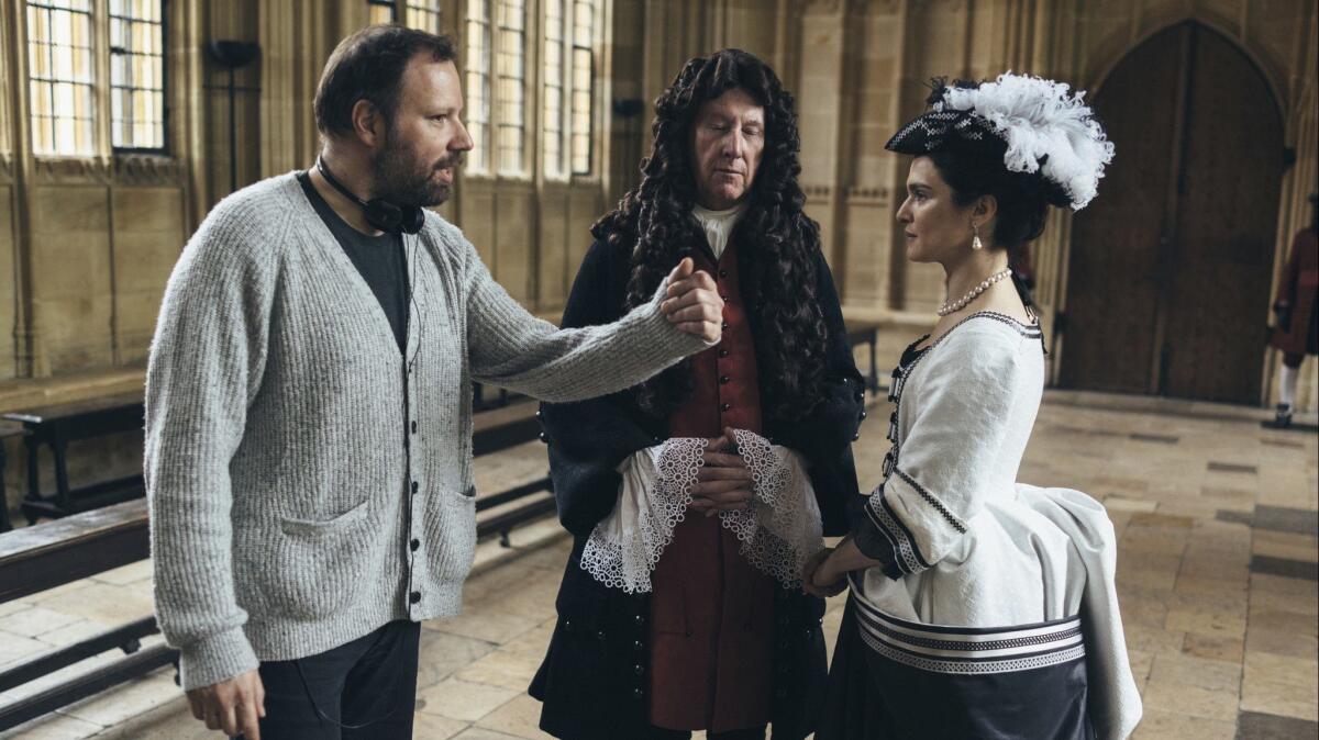 Director Yorgos Lanthimos, left, with actors James Smith and Rachel Weisz on the set of "The Favourite."