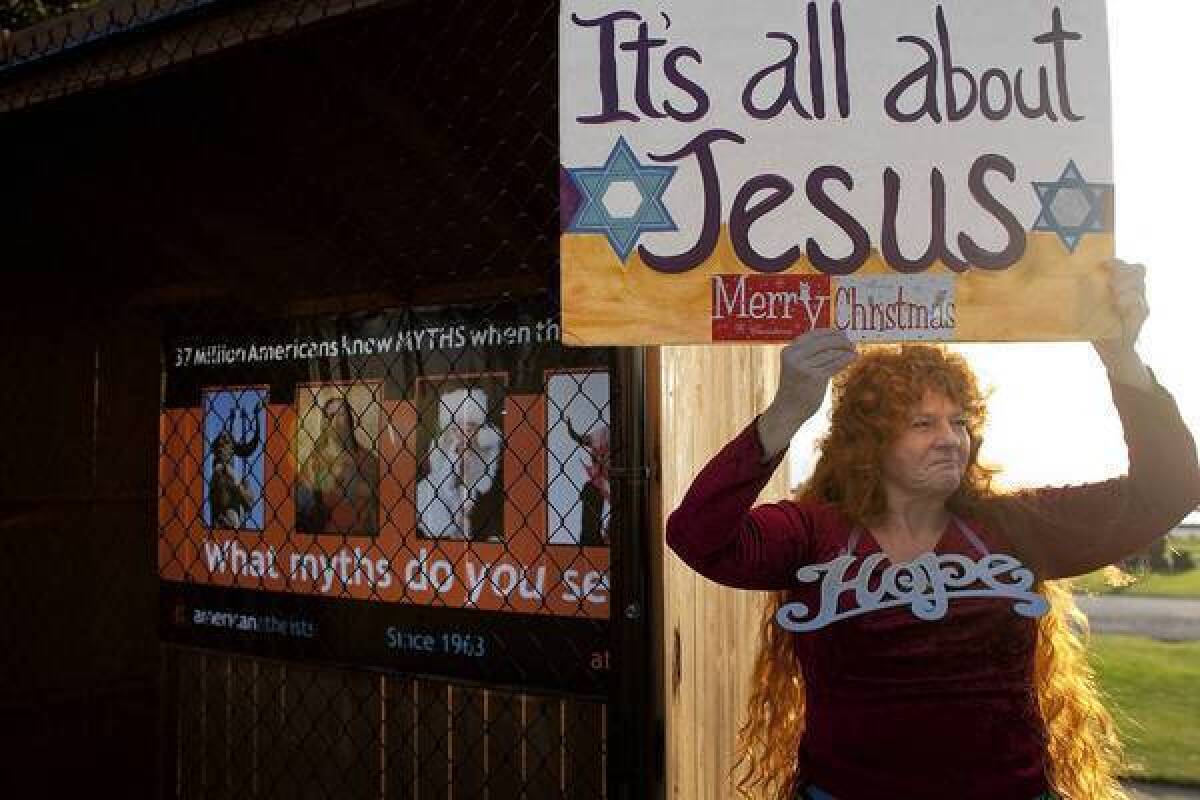 Vikki Hill of Santa Monica protests in front of an atheist group's display in December 2011 where Nativity scenes used to be at Palisades Park along Ocean Avenue.