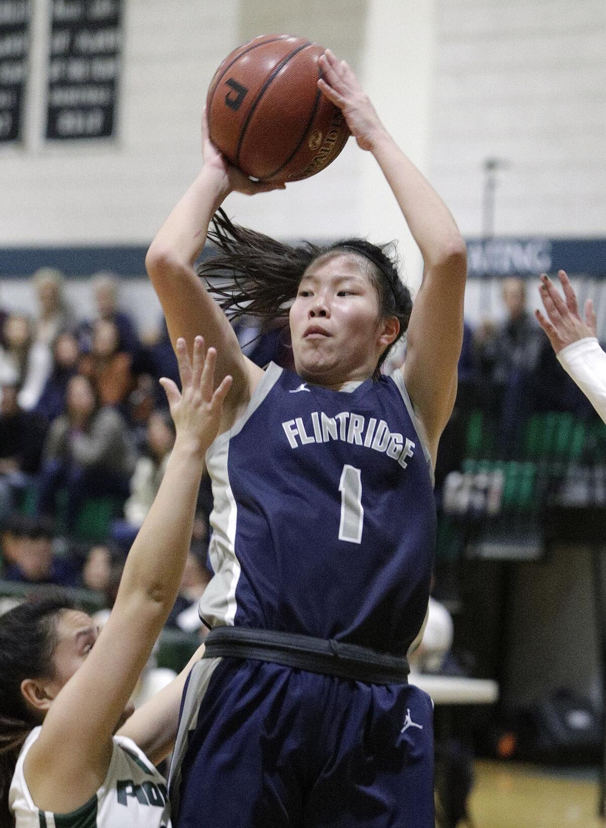 Flintridge Prep's Kaitlyn Chen drives and shoots against Providence's Sydney Sayoc in a Prep League girls' basketball game Friday at Providence.