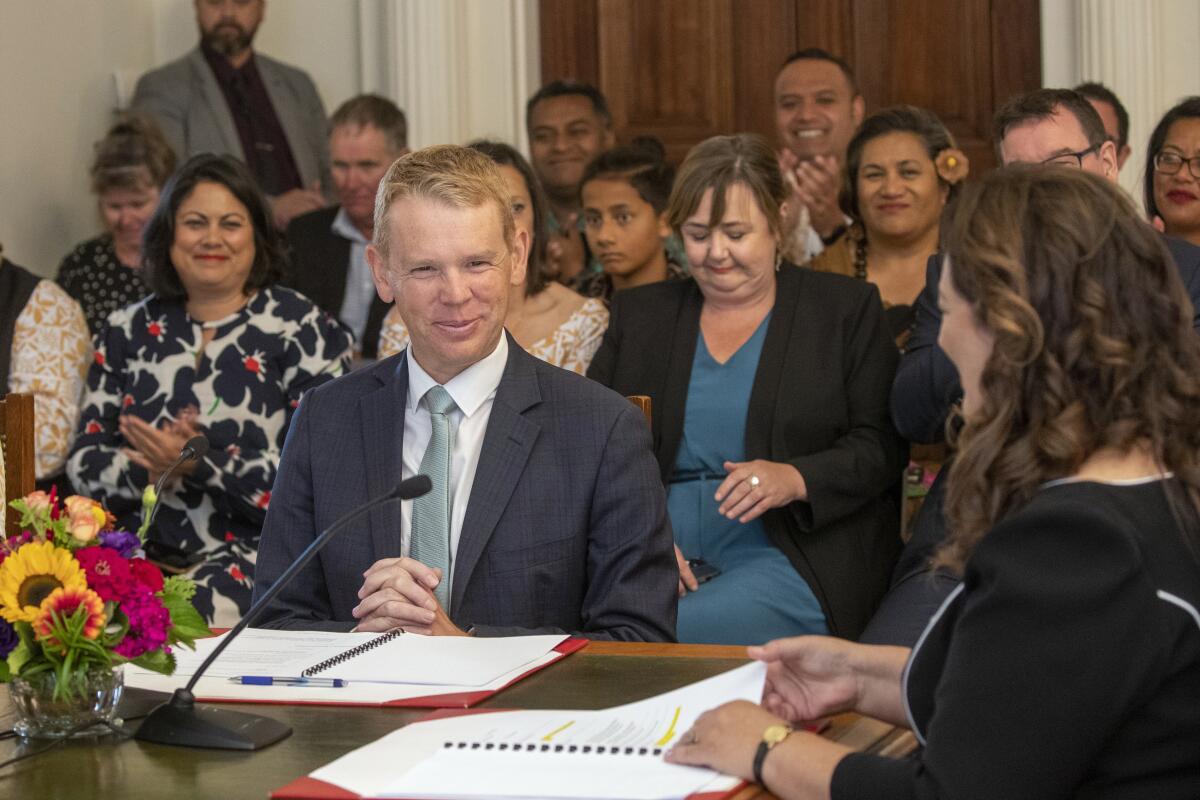 New Zealand's new Prime Minister Chris Hipkins being sworn in before an audience