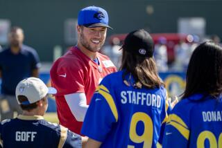 Irvine, CA - July 27: Rams quarterback Matthew Stafford greets fans as he arrives at Rams training camp.