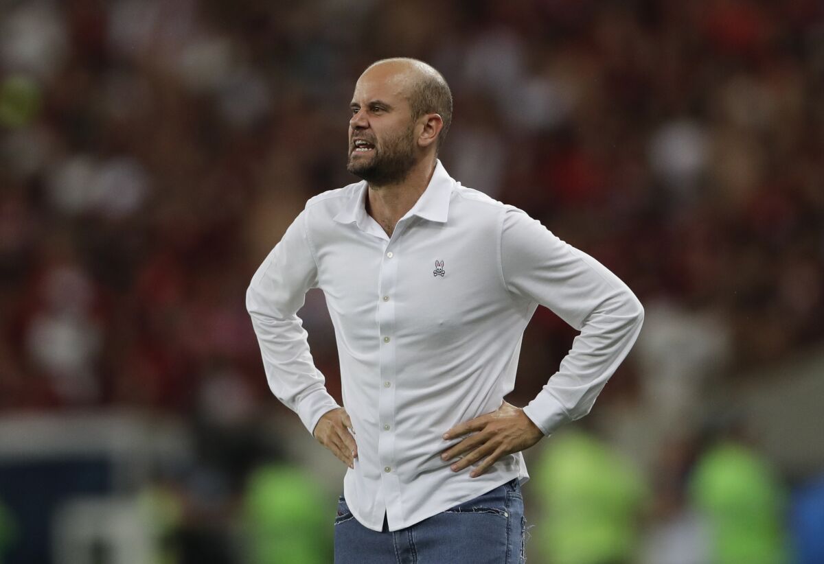 Coach Miguel Ángel Ramírez instructs players during a match.