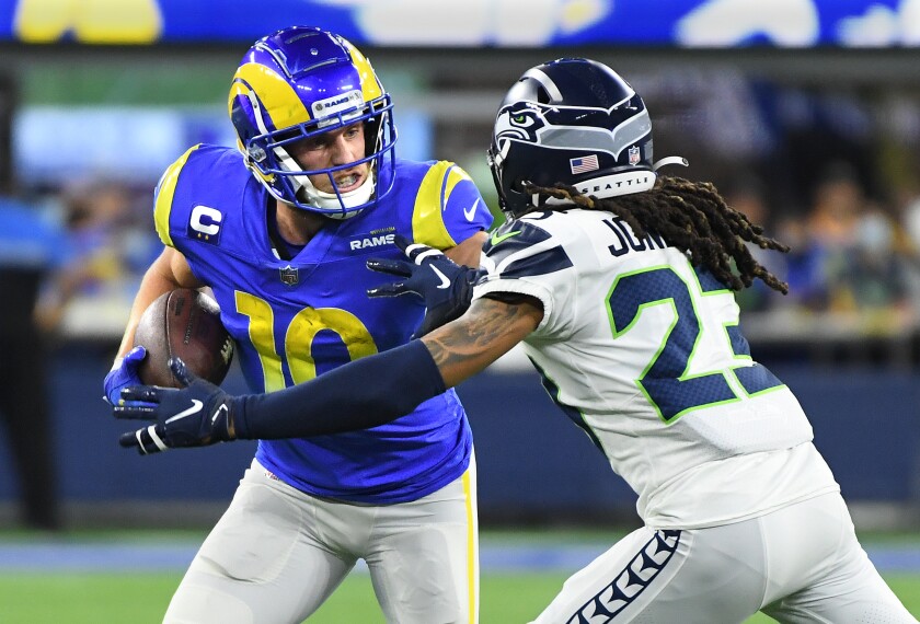 Rams receiver Cooper Kupp stiff-arms Seahawks cornerback Sidney Jones after making a catch in the second quarter.