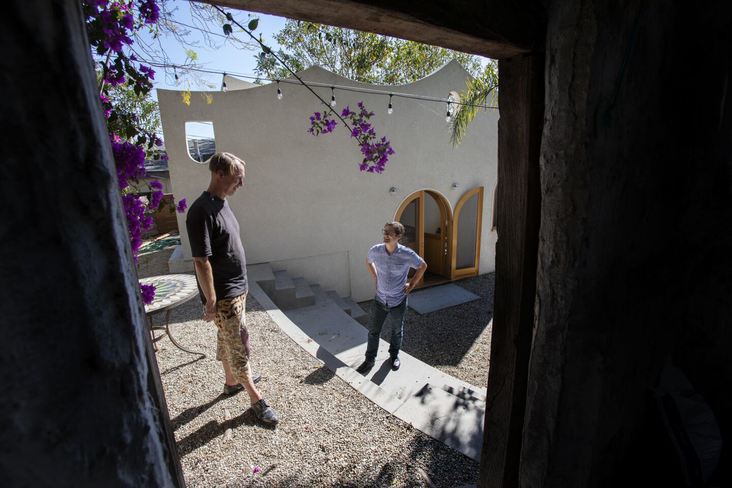 Ben Warwas, left, and Chris Skeens in the backyard, which is its own space. “Because it’s on an intense hill, we saw the building as an extension of the landscape,” says Skeens.