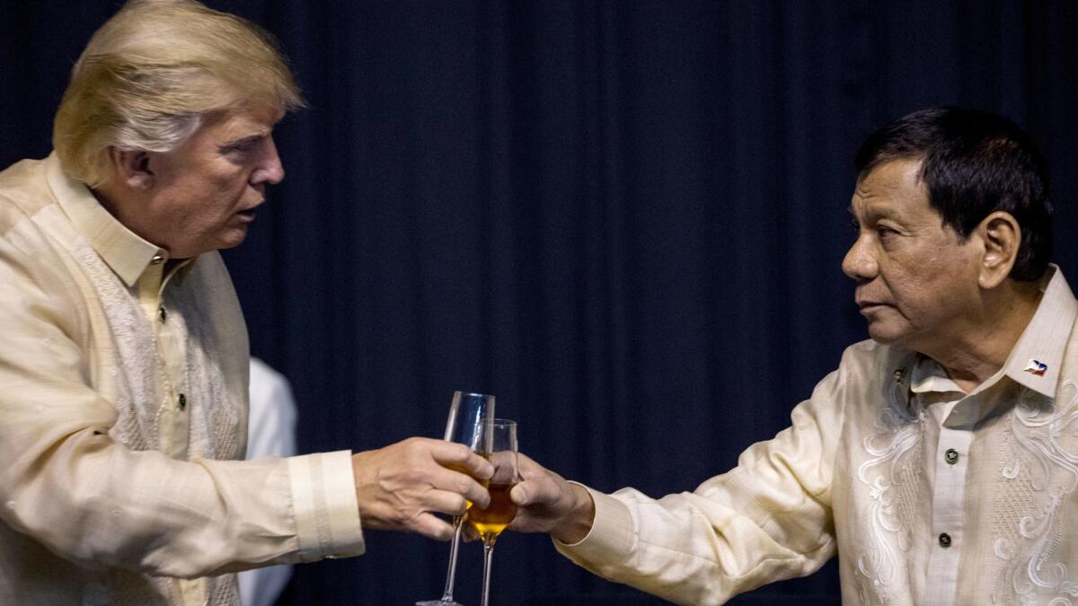 President Donald Trump toasts Philippines President Rodrigo Duterte, right, at an ASEAN Summit dinner, Nov. 12, 2017, in Manila.