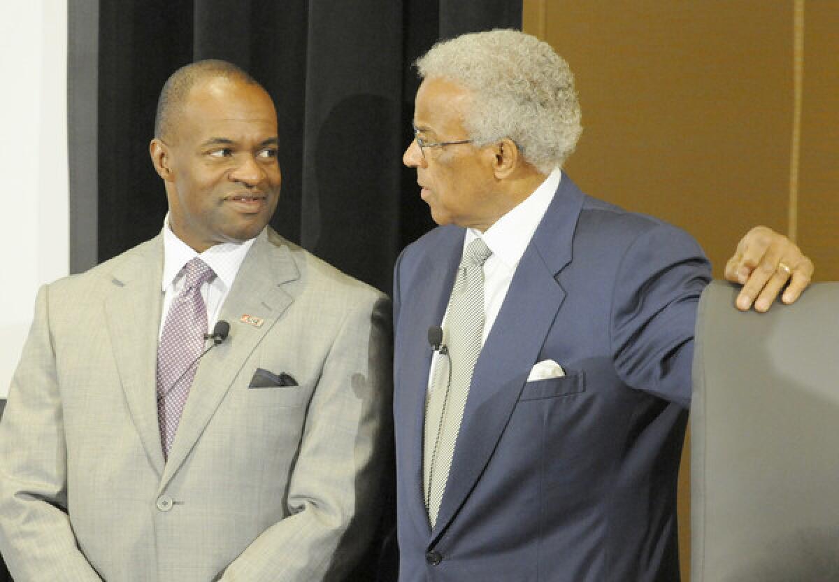 NBA Players Association executive director Billy Hunter, right, and NFL Players Association executive director DeMaurice Smith talk during a seminar held by the National Bar Association in Baltimore.