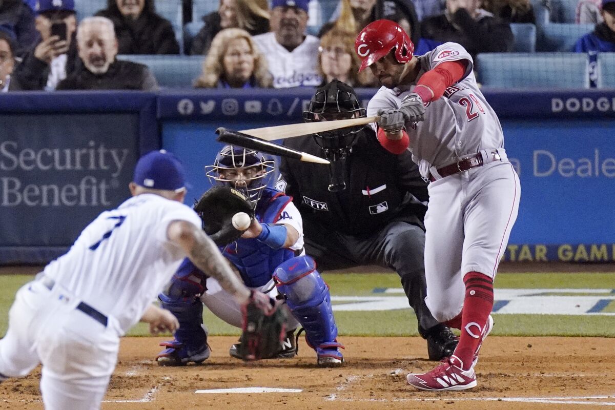 Cincinnati's Tommy Pham, right, breaks his bat as he grounds out against Dodgers pitcher Julio Urías.