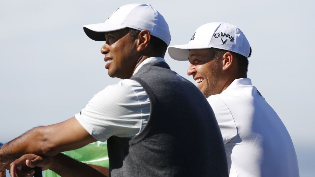 Tiger Woods and Xander Schauffele talk while waiting to play on the 3rd hole of Torrey Pines south course during the first round of the Farmers Insurance Open on Jan. 24, 2019. (Photo by K.C. Alfred/San Diego Union-Tribune)