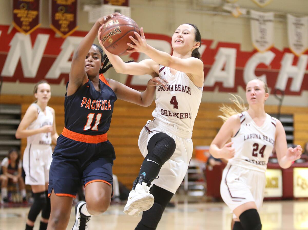Laguna Beach's Anna Cheng (4) beats Pacifica Christian Orange County's Marta Harrison to a rebound in nonleague game at home Friday.