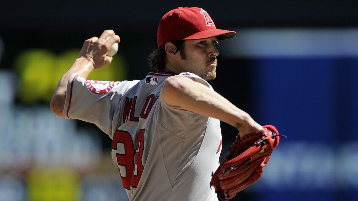 Angels starter C.J. Wilson delivers a pitch during the first inning of a 14-4 win over the Minnesota Twins on Sunday.