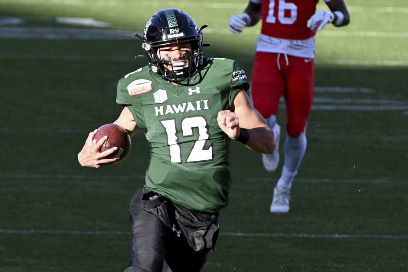 Hawaii quarterback Chevan Cordeiro (12)(12) runs upfield for a long gain in the second quarter.