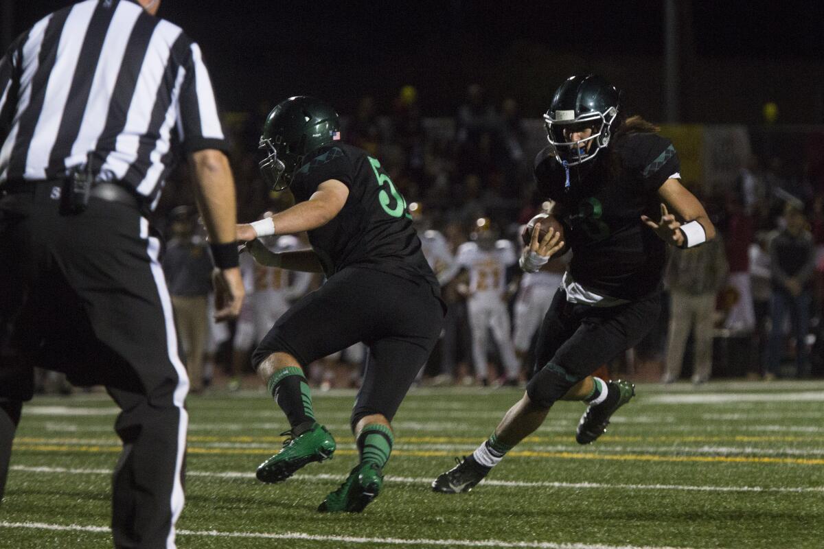 Costa Mesa's Nick Burton runs for a four-yard touchdown in the second quarter against Estancia in the Battle for the Bell rivalry game on Friday.