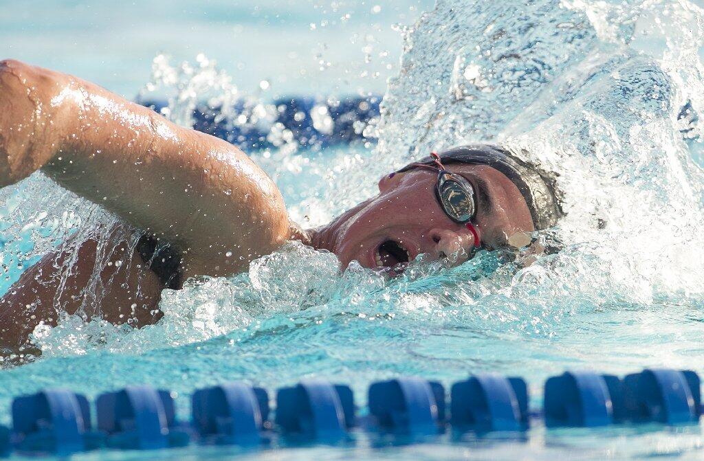 Corona del Mar's Robert Genc competes in the 500-yard freestyle during a Pacific Coast League meet against Irvine at Woollett Aquatic Center on Wednesday.