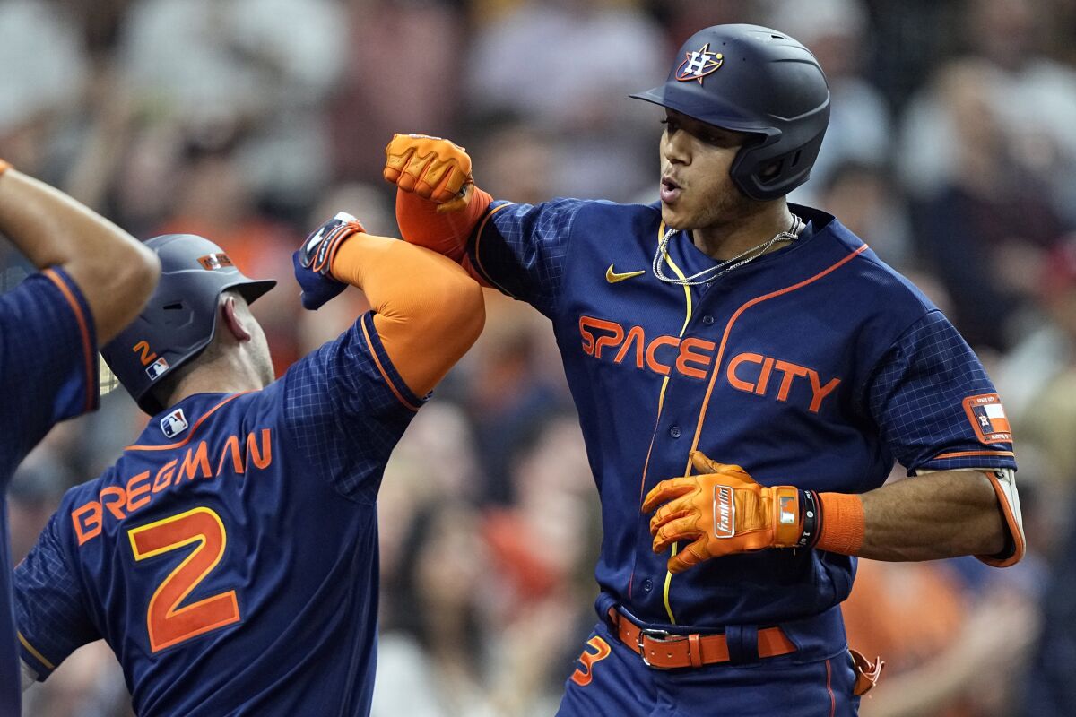 Houston Astros' Jeremy Pena (3) celebrates with Alex Bregman (2) after hitting a two-run home run against the Seattle Mariners during the sixth inning of a baseball game Monday, May 2, 2022, in Houston. (AP Photo/David J. Phillip)