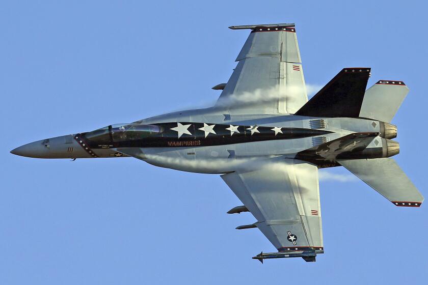 FILE - In this Feb. 28, 2017, file photo, vapor trails are seen forming on an F/A-18E Super Hornet over Death Valley National Park, Calif. The Navy says a fighter jet has crashed in the Mojave Desert but its pilot safely ejected. The F/A-18E Super Hornet from Naval Air Station Lemoore in California's Central Valley went down Tuesday, Oct. 20, 2020, in Superior Valley south of Naval Air Weapons Station China Lake. (AP Photo/Ben Margot, File)