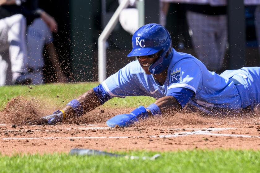 Kansas City Royals' Dairon Blanco dives safely across home plate on a single by Royals' Nick Pratto during the second inning of a baseball game against the New York Yankees, Sunday, Oct. 1, 2023, in Kansas City, Mo. (AP Photo/Reed Hoffmann)