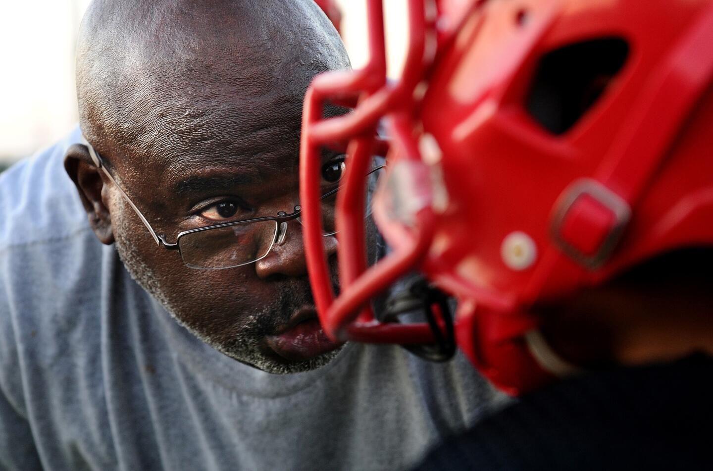 Football coach and youth sports program president Keith Johnson instructs a player during practice at Gompers Middle School in South Los Angeles. The Falcons’ motto says it all: “Teaching New-Style Kids Old-School Values.”