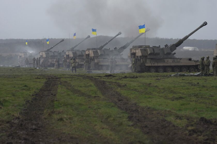 Ukrainian soldiers take part in a military exercise at a military training camp in an undisclosed location in England, Friday, March 24, 2023. The second cohort of Ukrainian artillery recruits come to the end of their training on the formidable AS90 155mm self-propelled gun. (AP Photo/Kin Cheung)