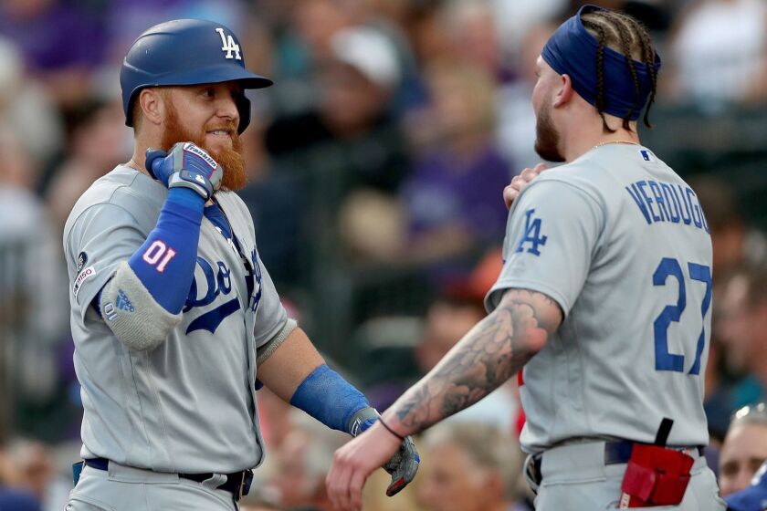 DENVER, COLORADO - JUNE 27: Justin Turner #10 of the Los Angeles Dodgers is congratulated by Alex Verdugo #27 after hitting a solo home run in the fifth inning against the Colorado Rockies at Coors Field on June 27, 2019 in Denver, Colorado. (Photo by Matthew Stockman/Getty Images) ** OUTS - ELSENT, FPG, CM - OUTS * NM, PH, VA if sourced by CT, LA or MoD **
