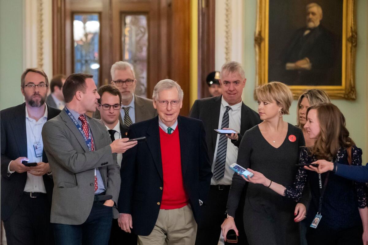 Senate Majority Leader, Republican Mitch McConnell, center, is surrounded by reporters after leaving the Senate chamber at the US Capitol in Washington, DC.