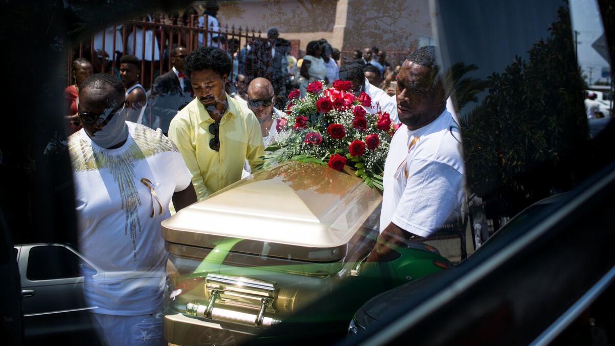 Pallbearers carry the casket of DeAndre Hughes into a hearse in Compton. His mother, Barbara Pritchett-Hughes, said her mind instantly flashed back to nine years earlier when her 15-year-old son, Dovon Harris, was fatally shot in Watts.