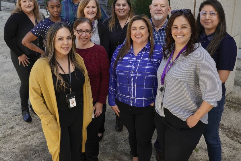 SAN DIEGO, CA - MARCH 24: Members of the County of San Diego's Alzheimer's Response Team. Front row, left, Silvia Gomez, Denise Kidd, Andrea Echavarria, and Marisa Arellanes, right. Second row, left, Nadege Auguste, Kimberly Ingram, Claudia Lopez, Walter Tolbert, and Amanda Echeverria, right. Back row, left, Verenice Bakry, left, and Damion Romero, right. Photographed Friday March 24, 2023. (Howard Lipin / For The San Diego Union-Tribune) Note: Only able to do group photo outside of offices, because of privacy concerns. Top person wasn't there and second in charge didn't want to be singled out.