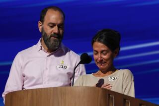 Chicago, Ill, Wednesday, August 21, 2024 - Jon Polin comforts Rachel Goldberg as she breaks down while talking about their son, Hersh Goldberg-Polin, an American-Israeli hostage who had been held in the Gaza Strip after being abducted by Hamas. They are speaking at the Democratic National Convention at the United Center.(Robert Gauthier/Los Angeles Times)