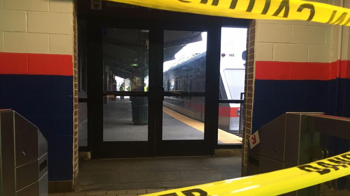 Police tape blocks off a train track at the 69th Street Terminal in Upper Darby, Pa., after a train collision early Aug. 22 injured dozens.