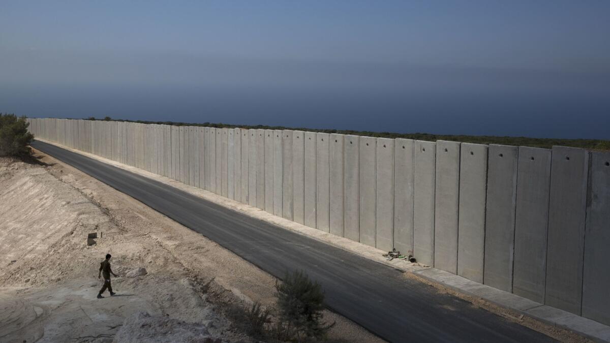 An Israeli soldier near a wall at the Israel-Lebanon border near Rosh Haniqra, Israel.