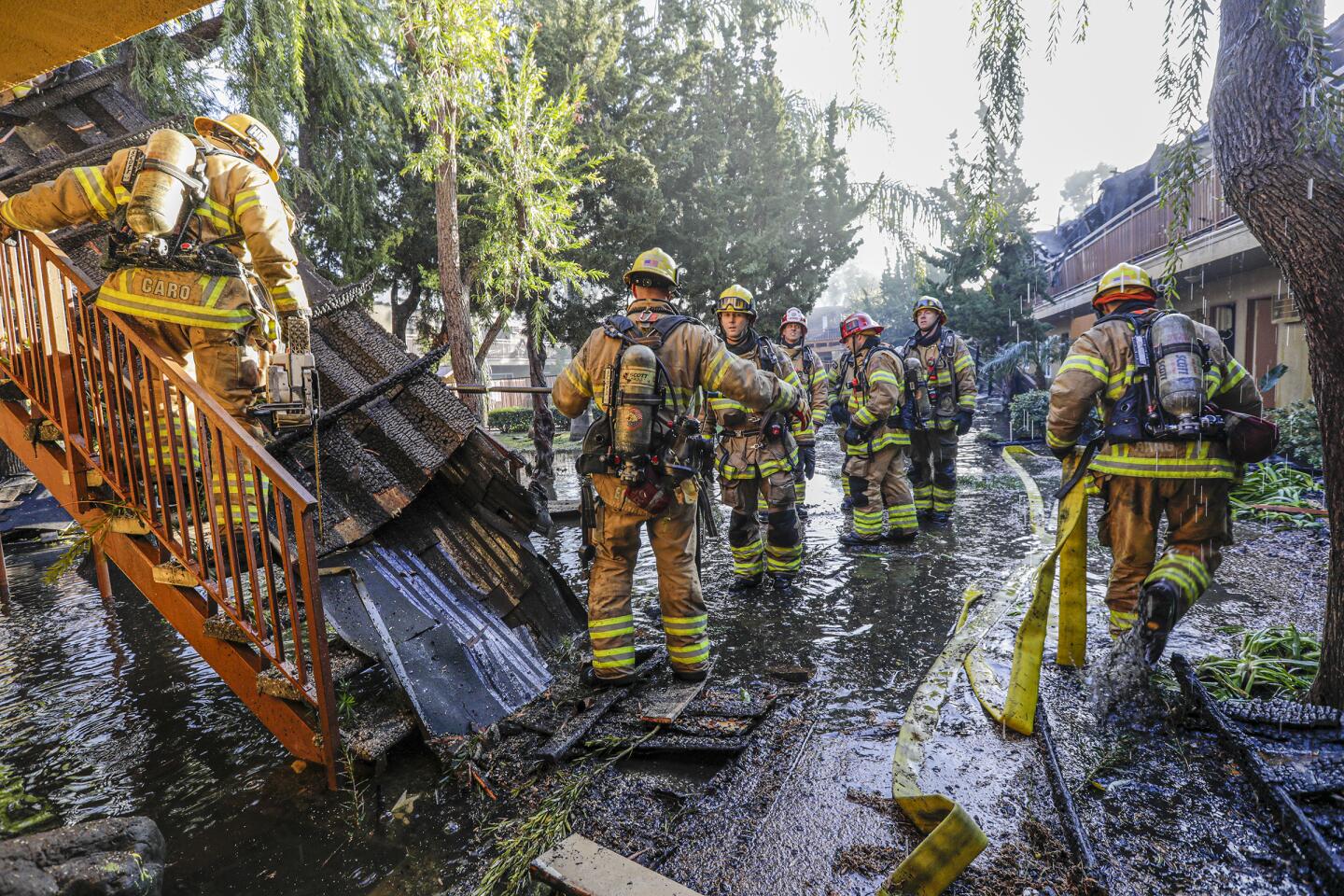 TUSTIN, CA - FEBRUARY 12 , 2020 - A five-alarm fire that caused the roof of a building in a two-story apartment complex in Tustin to collapse today left two residents injured, and firefighters were working to douse hot spots and determine if anyone was unaccounted for. The fire was first reported at 3:01 a.m. at 15751 Williams Street, near McFadden Avenue, according to the Orange County Fire Authority. (Irfan Khan / Los Angeles Times)
