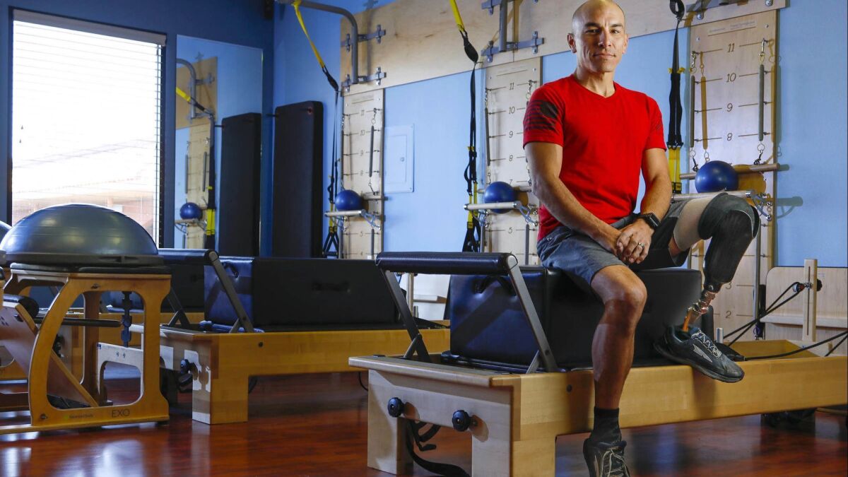 Retired Marine Corps Sgt. Calvin Smith, 37, at the Club Pilates gym in San Marcos. After 21 surgeries, a traumatic brain injury and the loss of a leg, the Vista resident has found a new calling as a Pilates instructor.