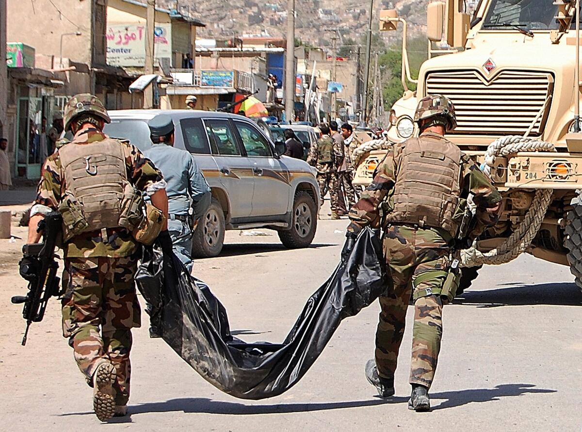 French soldiers with the NATO-led International Security Assistance Force in Afghanistan carry away the body of a suicide attack victim in Kabul.