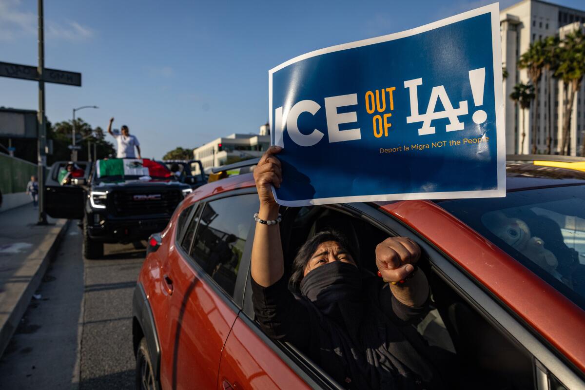 Demonstrators protest outside the Edward R. Roybal Federal Building and the Metropolitan Detention Center