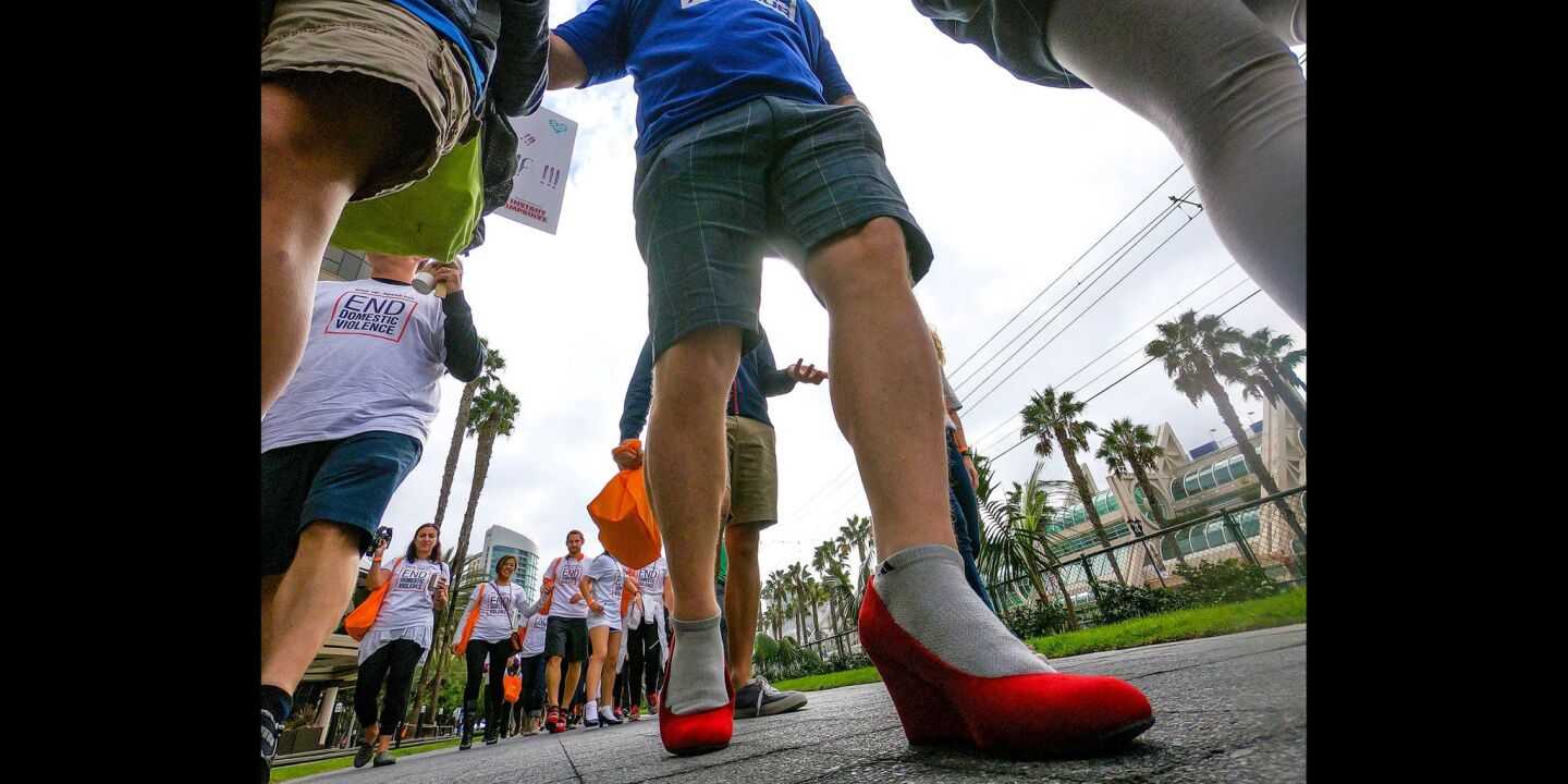 Bill Breen of Del Mar, sporting red high heels was one of a couple of hundred people to walk through the Gaslamp Quarter during the YMCA'S 11th annual "Walk a Mile in Her Shoes," taking a stand against domestic violence.