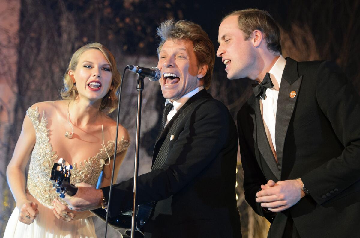 Britain's Prince William, the Duke of Cambridge, right, sings with Taylor Swift, left, and Jon Bon Jovi at the Centrepoint Gala Dinner at Kensington Palace in London in November. Centrepoint is a charity supporting homeless young people aged 16-25 and Prince William is patron of the organization.
