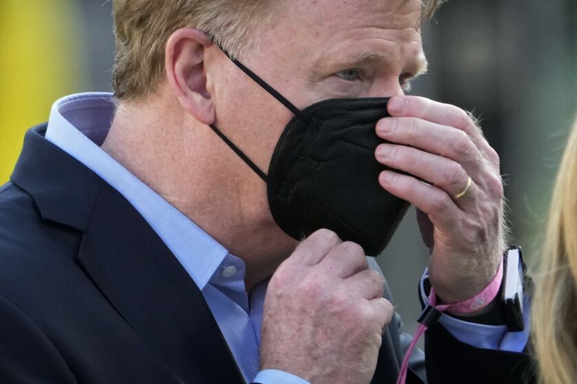 Commissioner Roger Goodell adjusts his mask before the NFL Super Bowl 55 football game between the Kansas City Chiefs and Tampa Bay Buccaneers, Sunday, Feb. 7, 2021, in Tampa, Fla. (AP Photo/David J. Phillip)