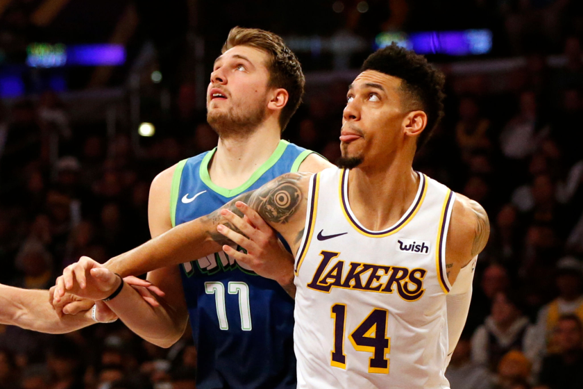 Dallas Mavericks guard Luka Doncic, left, battles for position with Lakers guard Danny Green.