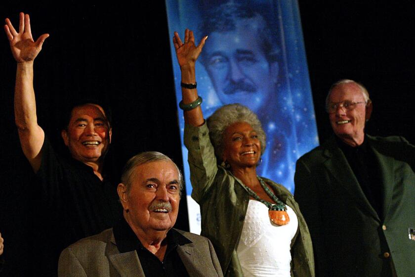 George Takei, left, the late James Doohan, Nichelle Nichols and the late Neil Armstrong are shown in 2004 at a "Star Trek" convention.