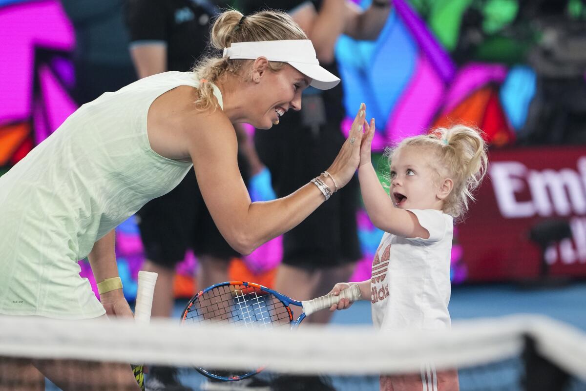 Caroline Wozniacki high-fives her daughter Olivia during a charity event last month at the Australian Open.
