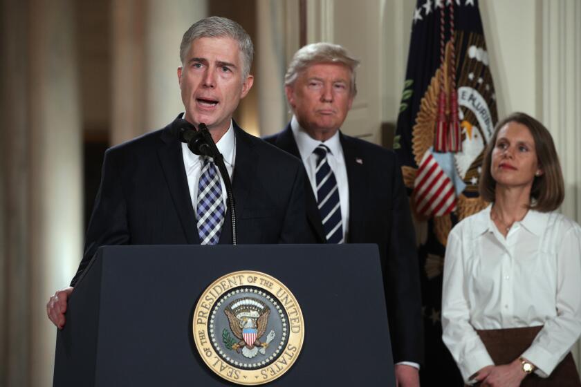 Judge Neil Gorsuch speaks after being nominated by President Donald Trump to the Supreme Court during a ceremony at the White House as his wife, Marie Louise, looks on Jan. 31, 2017.