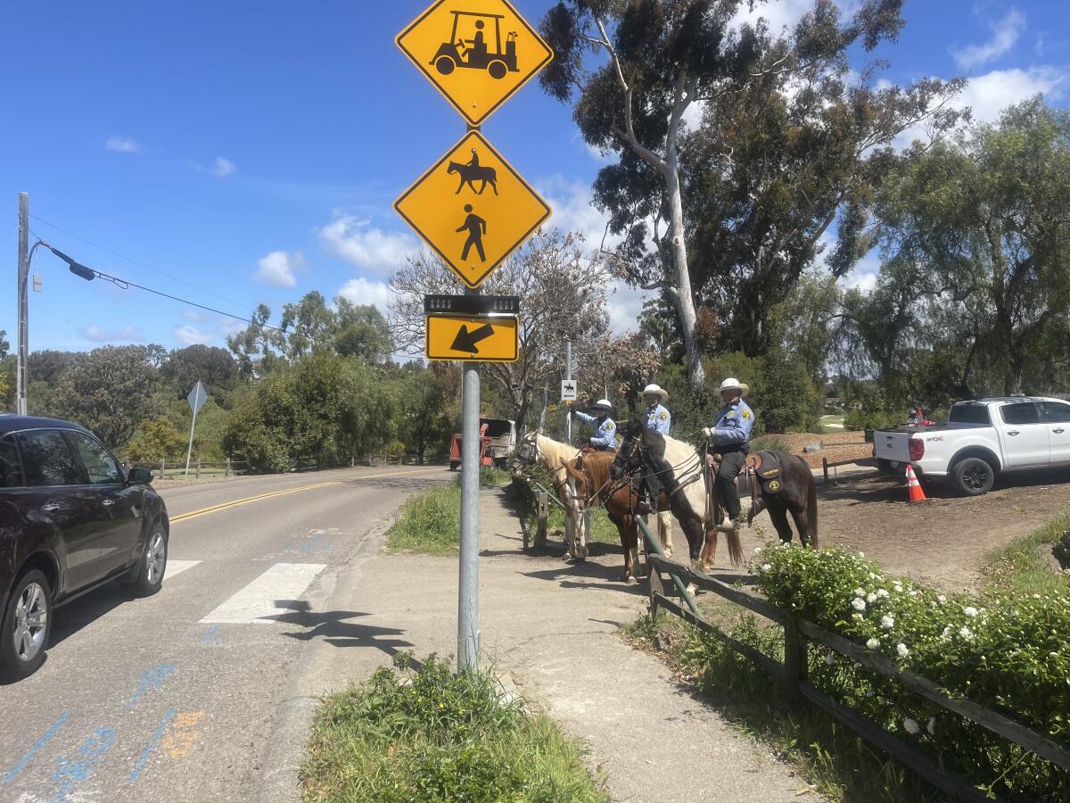 Members of the San Diego County Sheriff's Department's Volunteer Mounted Unit prepare to cross at La Granada.
