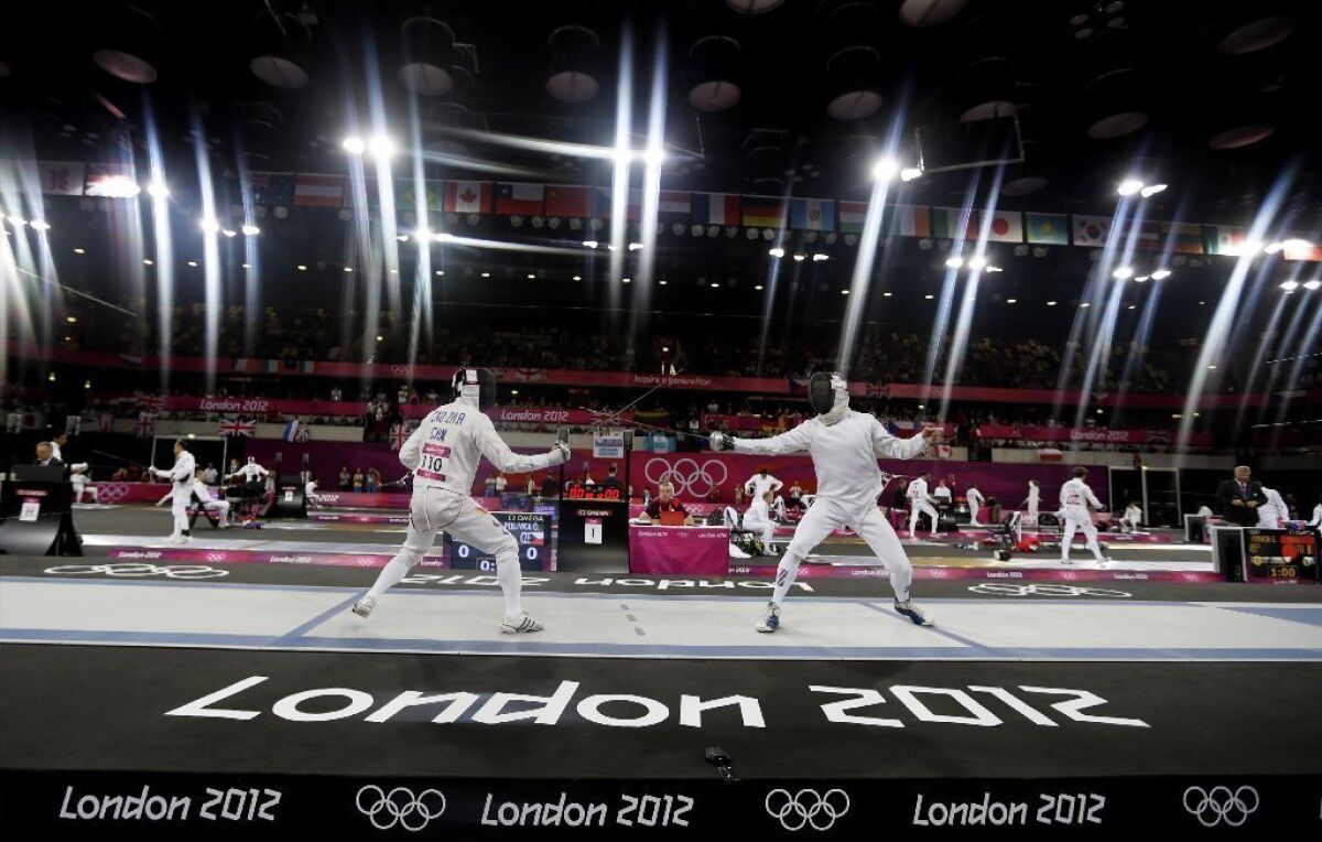ICao Zhongrong of China, left, and Ondrej Polivka of the Czech Republic compete during the fencing section of the men's modern pentathlon at the 2012 Summer Olympics. The pentathlon is one of the events under consideration for being dropped.